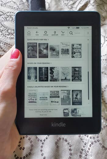 a reviewer holding the kindle