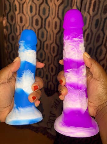 Blue and purple cloud dildos held in two hands