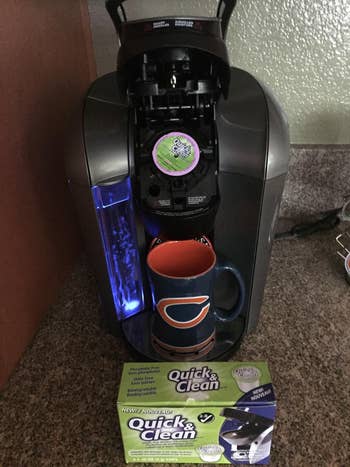 reviewer image of cleaning K-cup placed inside Keurig witht he box of tablets nearby 