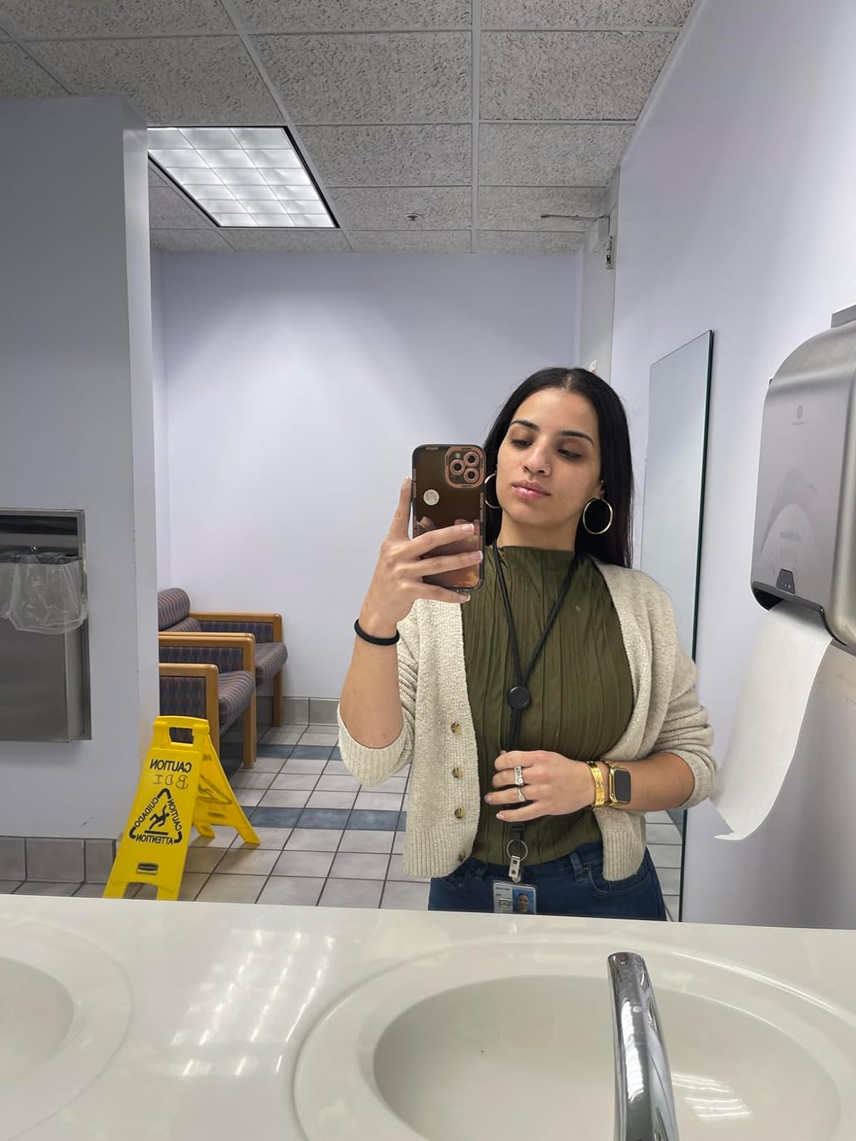 Person taking selfie wearing a cardigan over the green ruffled tank