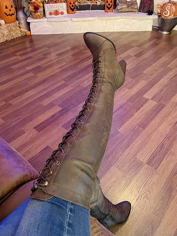 reviewer wearing brown lace-up knee-high boots