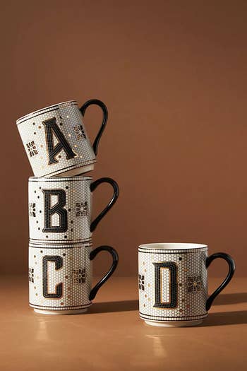 four tile monogrammed mugs with the letters 