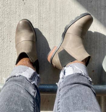 Reviewer wearing gray boots