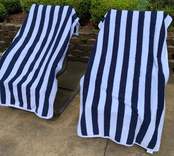 Reviewer image of white and blue towels on lounge chairs