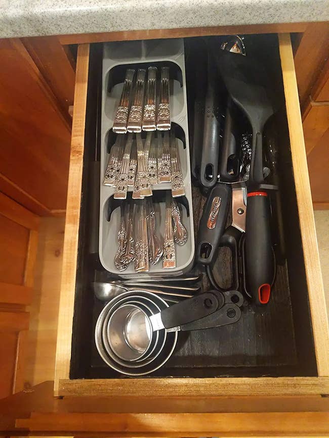 An open drawer with the silverware organizer on the left and enough space left over on the right and bottom for additional utensils