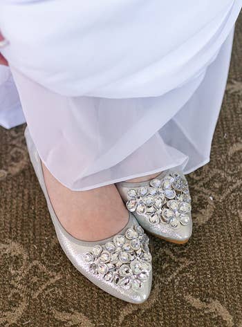 reviewer wearing the silver rhinestone flats with a wedding dress