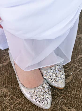 reviewer wearing the silver rhinestone flats with a wedding dress