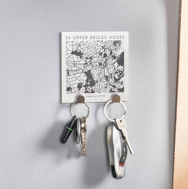 square personalized map with two silver hooks with keys on them
