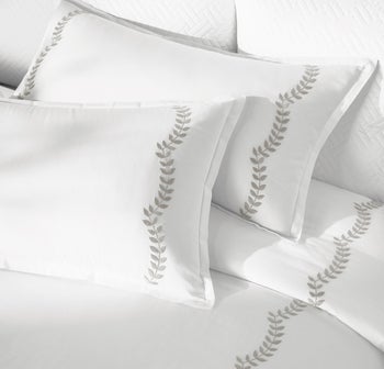 Close up of product with dark gray vines in a scalloped embroider 