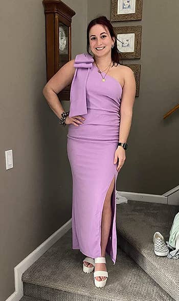 reviewer in the lilac one-shoulder dress with bow detailing