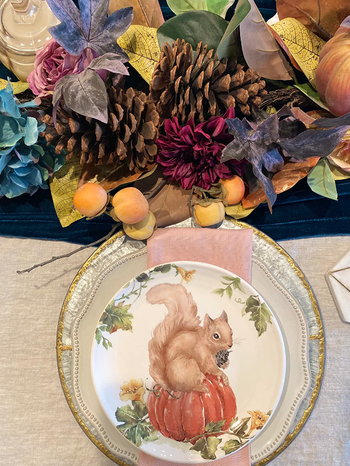reviewer image of the squirrel plate on decorated table prepped for a meal 