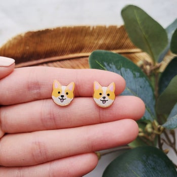 a pair of orange and white corgi earrings
