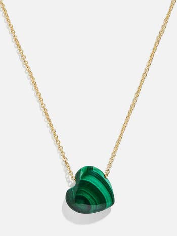 Pendant necklace with a green, heart-shaped stone on a gold chain 