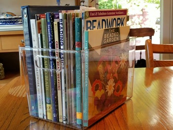 reviewer photo of books and magazines in clear storage bin