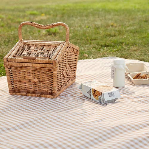 the tan gingham blanket with a picnic basket on it