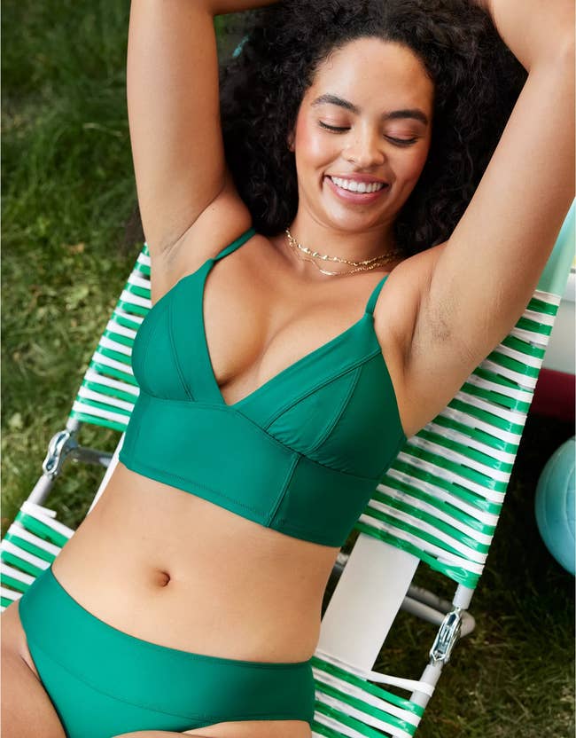a model wearing the top in green 