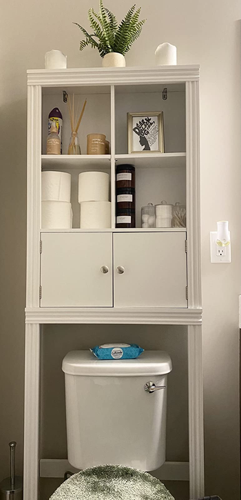 a reviewer photo of the storage cabinet over a toilet 