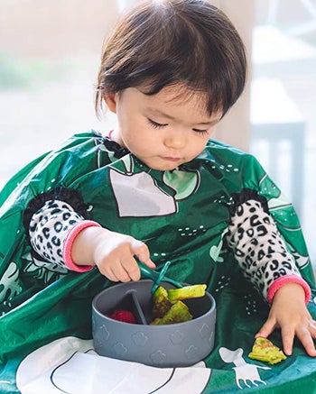 baby wearing the green bib