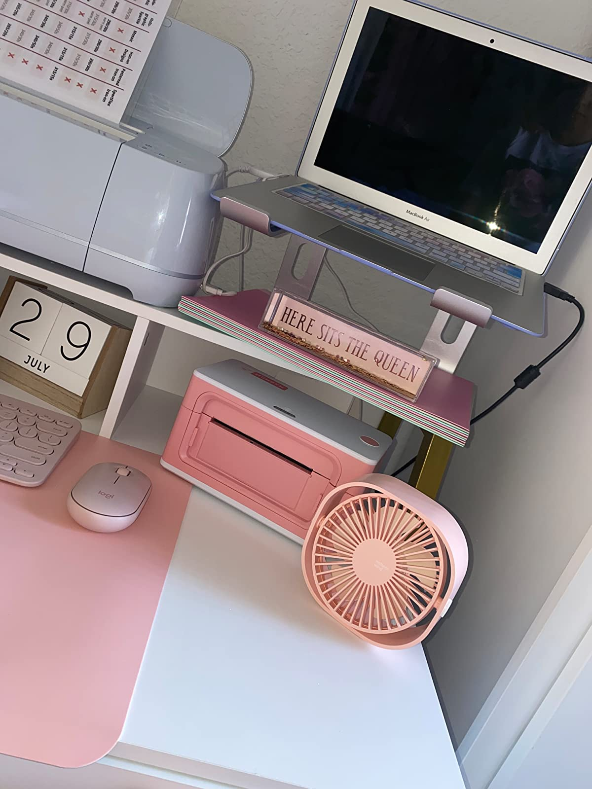A reviewer shows the pink fan on their desk