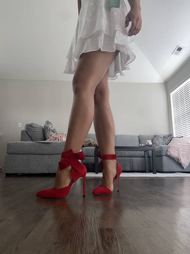 Reviewer wearing red pumps with bows