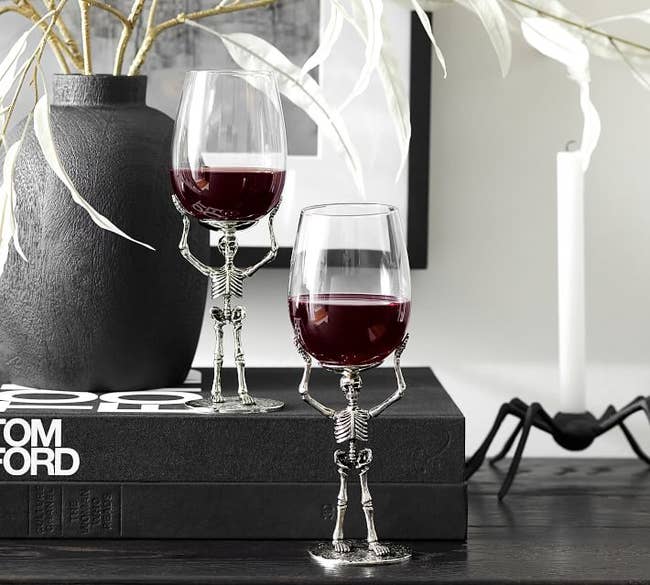 Image of two skeleton wine glasses holding red wine