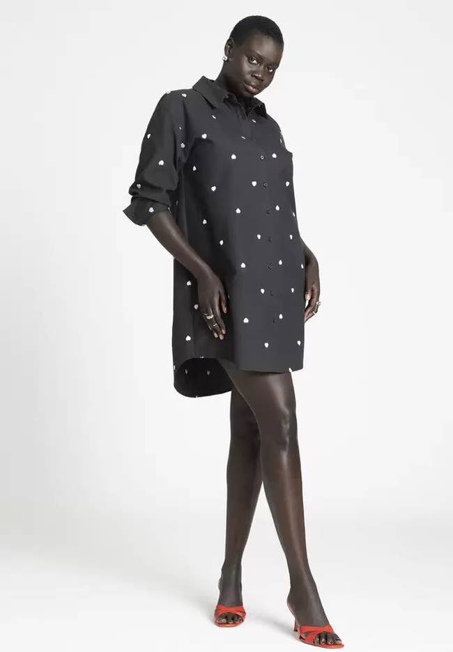 model in black long-sleeve dress with white hearts