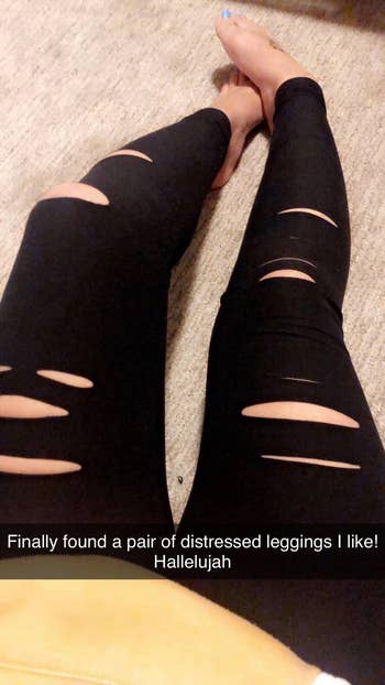 reviewer sitting on the floor, showing off black distressed leggings with multiple rips. Text reads: