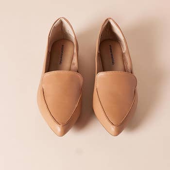 the pair of camel faux leather loafers