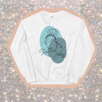 a white sweatshirt with an illustration of cinderella on it