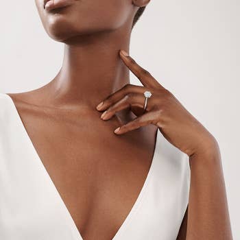 a model wearing the a brilliant cut solitaire diamond ring