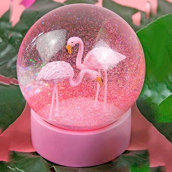 pink snowglobe with two flamingos in glitter