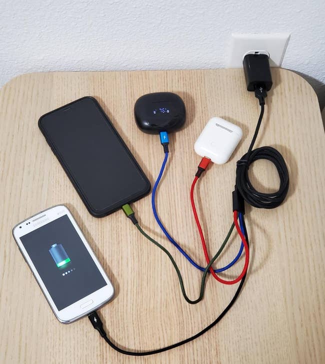 a reviewer photo of the 4-in-1 charging cord charging four separate devices 