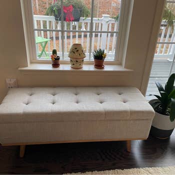 Reviewer's gray storage bench with wooden legs