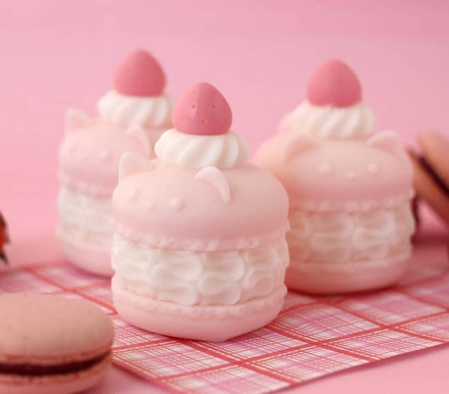 Light pink cat macaron shaped soaps with white icing in the middle and on top
