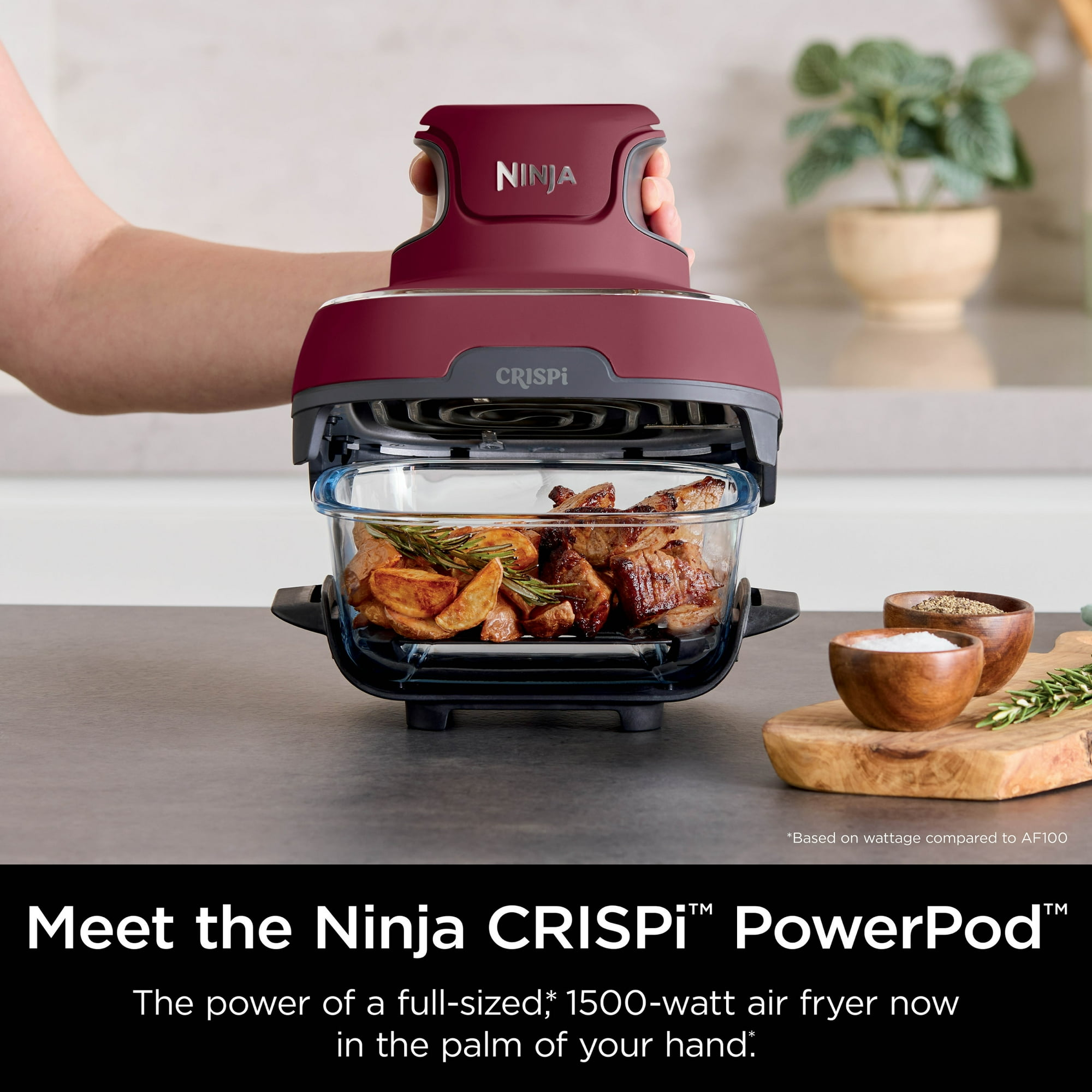 Air fryer successful  use, cooking nutrient   and potatoes. User's manus  holding the fryer lid. Kitchen mounting  with spices nearby. Ideal for speedy  meals
