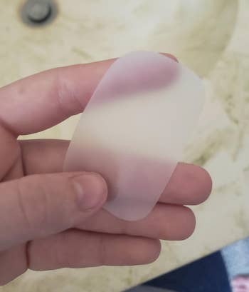 reviewer holding a paper soap sheet