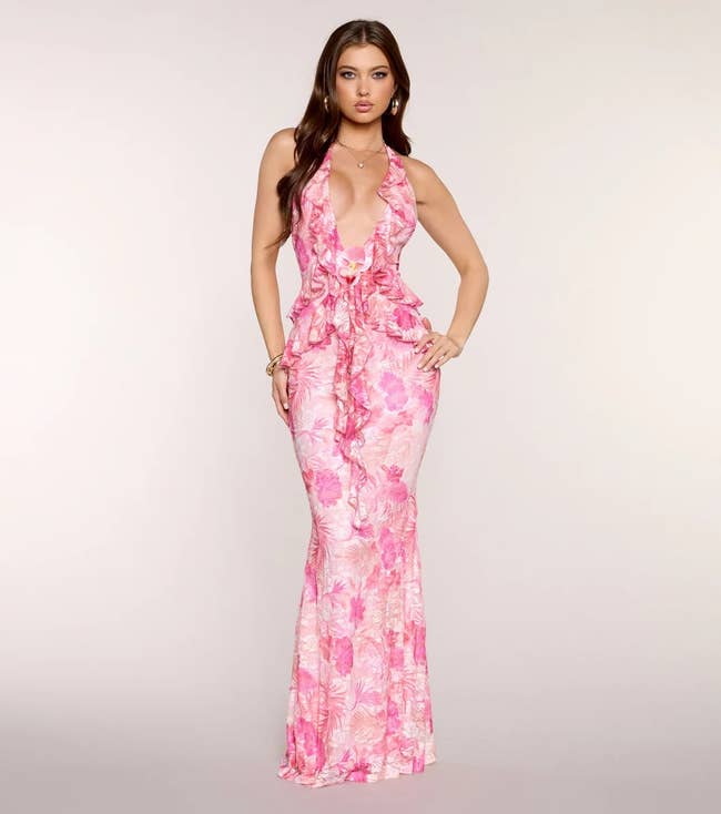 model successful a floral halter-neck gown with ruffles and mermaid silhouette