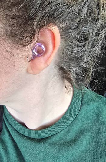 Person wearing a wide receptor gauge, showcasing jewelry style
