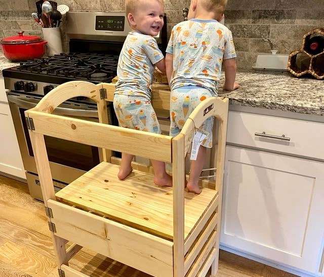 Twins standing in the learning tower