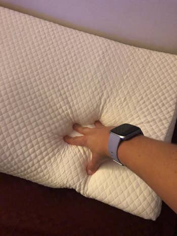 hand showing the foam in the pillow