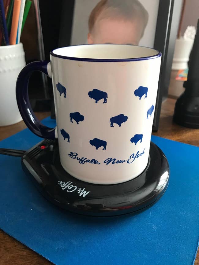 a reviewer's mug on a mug warmer
