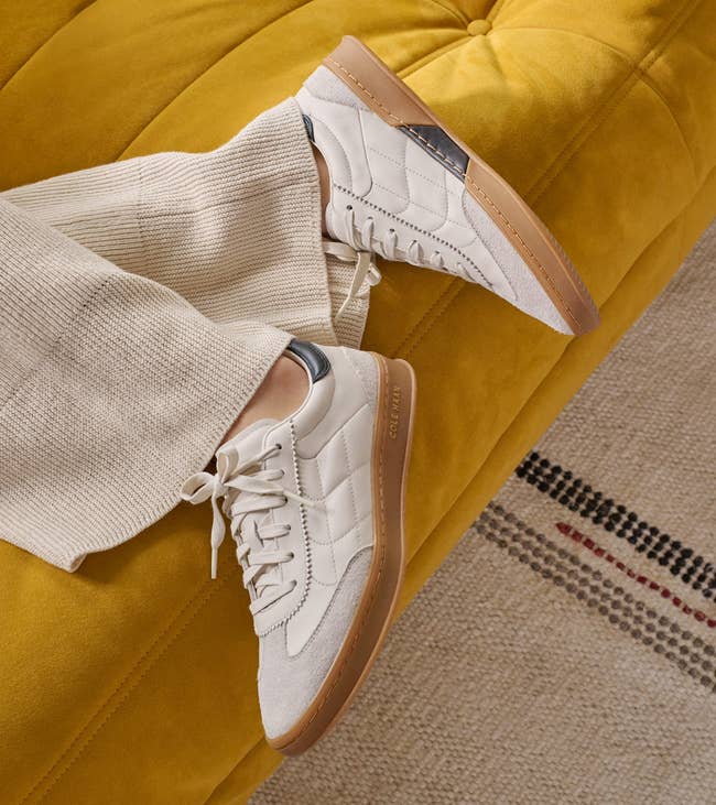 A idiosyncratic   wearing quilted achromatic  sneakers with brownish  soles