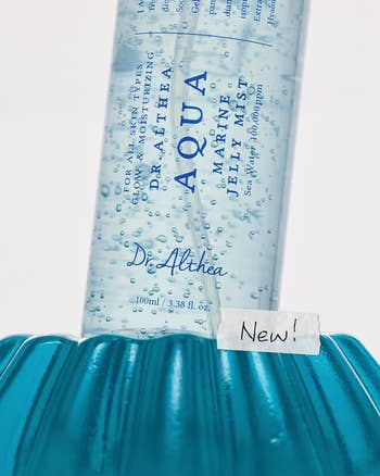 Aqua Marine Jelly Mist by Dr. Althea successful a vessel with bubbles, shown connected a bluish aboveground with a