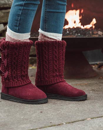 model wearing the knit boots in red