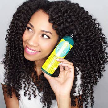 model with curly hair holding the curl control jelly