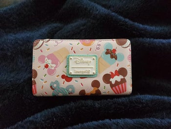 a wallet with cupcakes, sprinkles,a nd ice cream on it