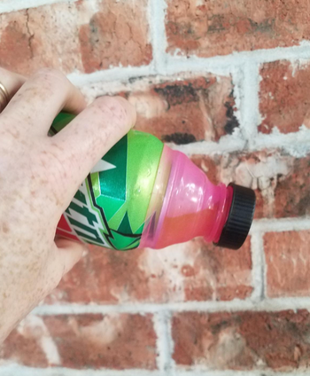 Reviewer tilting the can to show the leakproof seal 
