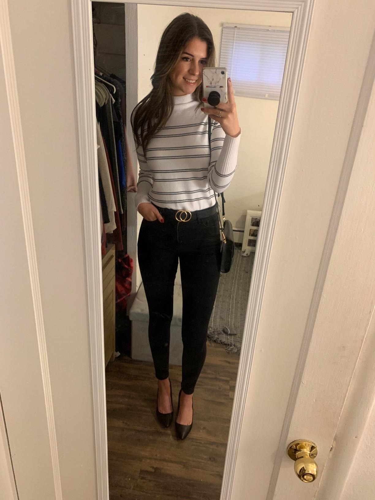 reviewer successful  striped apical  and achromatic  pants takes reflector  selfie, showcasing casual outfit and benignant   for a buying  article