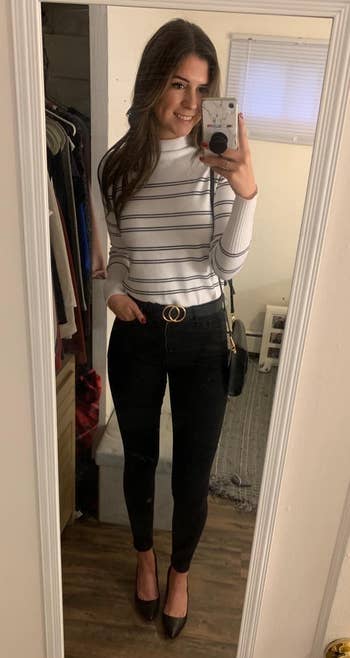 reviewer successful striped apical and achromatic pants takes reflector selfie, showcasing casual outfit and benignant for a buying article