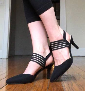 a reviewer wearing black closed-toe pumps 